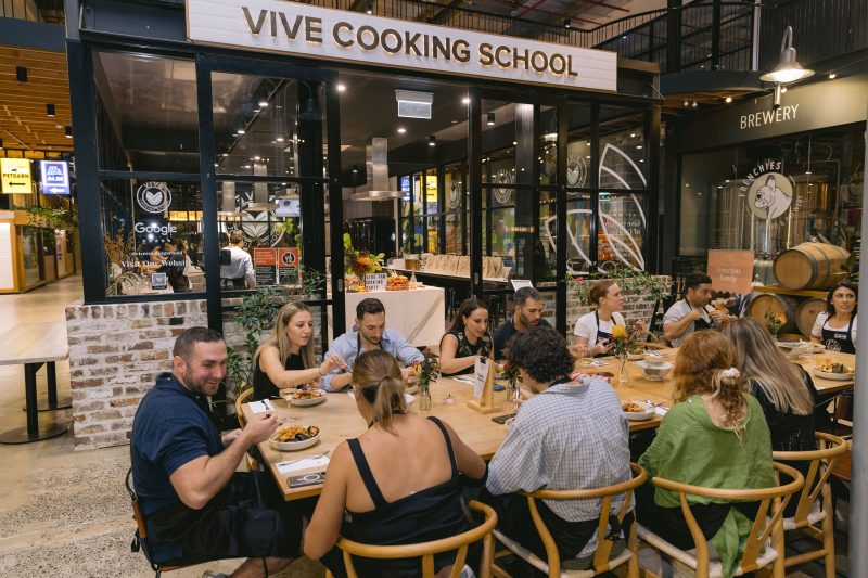 After cooking, students sit down and eat