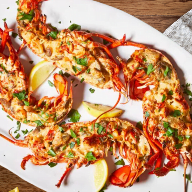 a plate of Lobsters with lemons and parsley