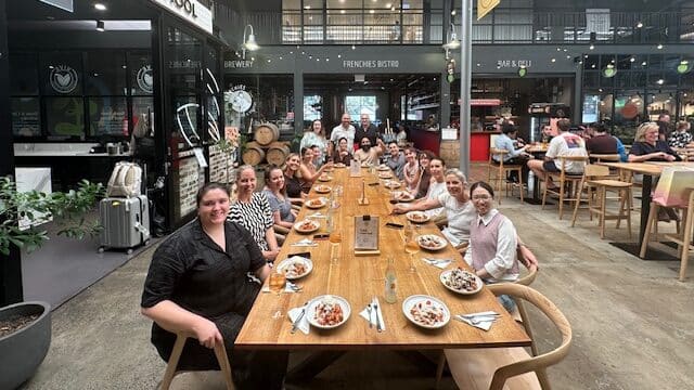 Team enjoying their meal together after a cooking class at VIVE