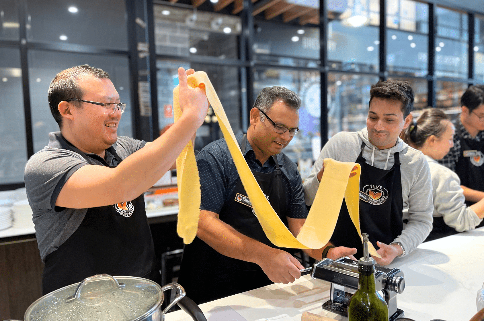 Teams collaborating in the VIVE kitchen during a team building cooking event